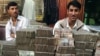 Afghanistan - Two Afghan money changers wait for customers at a money exchange market in Kabul, 18Jun2007