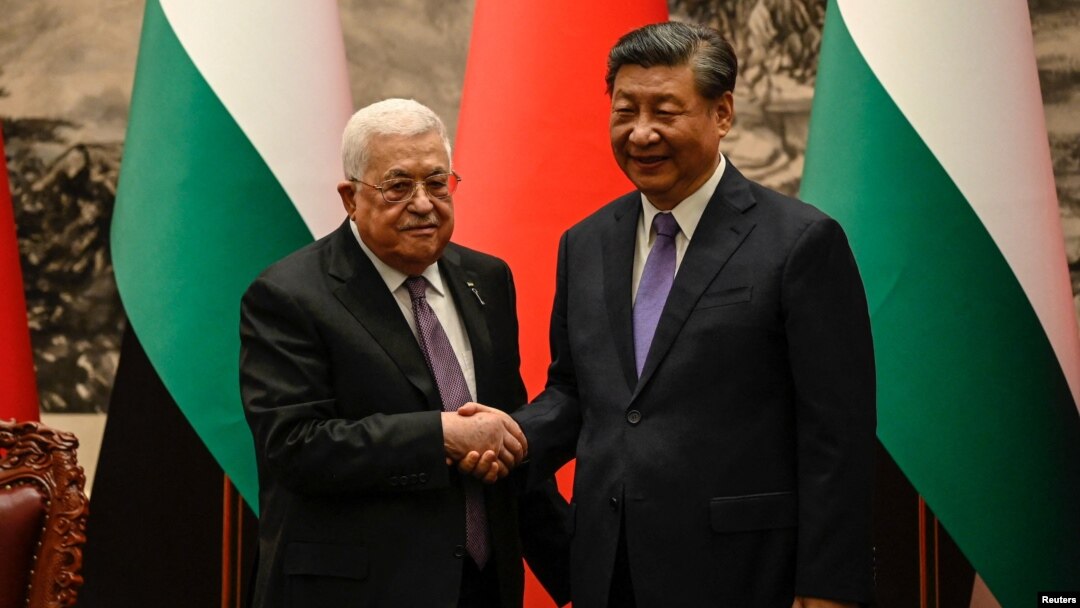 Palestinian President Mahmud Abbas (left) shakes hands with China's President Xi Jinping after a signing ceremony in the Great Hall of the People in Beijing on June 14. 