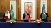 Najviši kineski diplomata Vang Ji drži sporazum potpisan 10. marta u Pekingu sa sekretarom iranskog Vrhovnog vijeća za nacionalnu sigurnost Alijem Šamhanijem i saudijskim državnim ministrom Musaadom bin Muhamedom al-Aibanom.