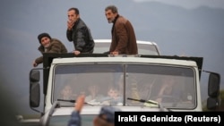 Ethnic Armenian refugees from Nagorno-Karabakh arrive by truck in the village of Kornidzor on the Armenian border on September 26, 2023. 
