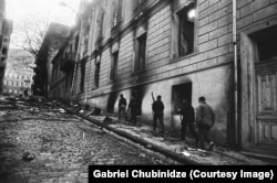 Gunmen walk up a street in central Tbilisi.