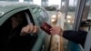 A Serbian traveler prepares his passport for control at the border with Hungary and Serbia in Horgos on December 19, 2009.