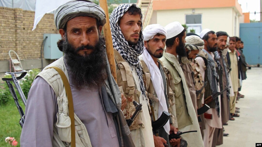 Afghan Taliban militants hand over weapons as part of a government peace-and-reconciliation process at a ceremony in Kunduz on May 6.