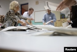 Bosnian Election Commission officials count votes after presidential and parliamentary elections at a polling station in a school in Sarajevo on October 2.