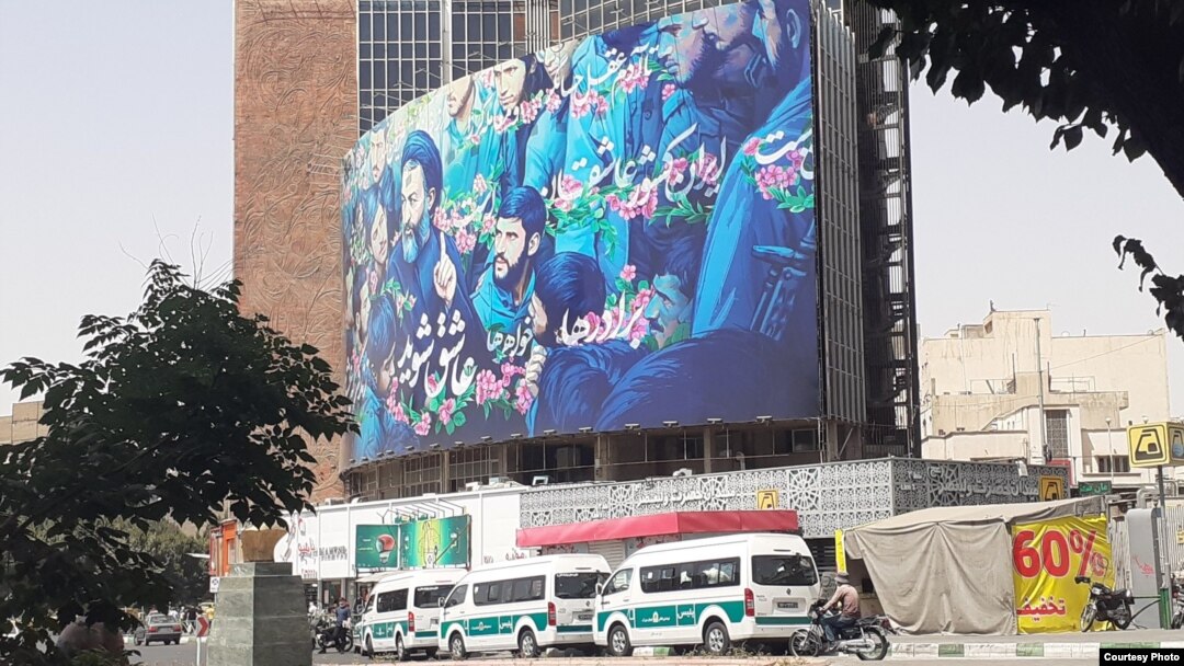Police cars wait to arrest women not wearing Islamic hijab in Tehran on July 6.