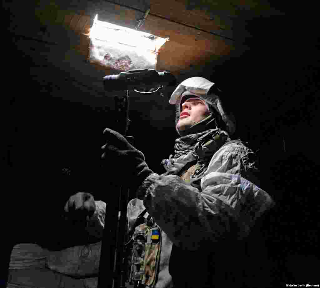A Ukrainian fighter looks out from a frontline position near Avdiyivka on January 25. 