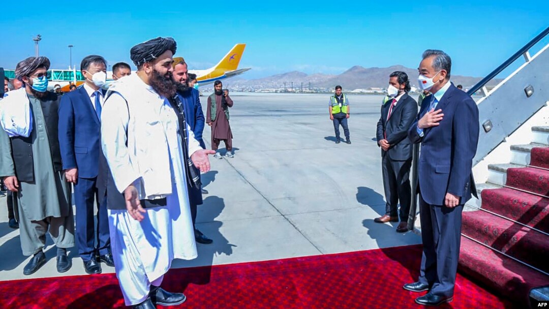 The Afghan Taliban's acting foreign minister Amir Khan Muttaqi (left) greets visiting Chinese diplomat Wang Yi (right) upon his arrival in Kabul last year. 