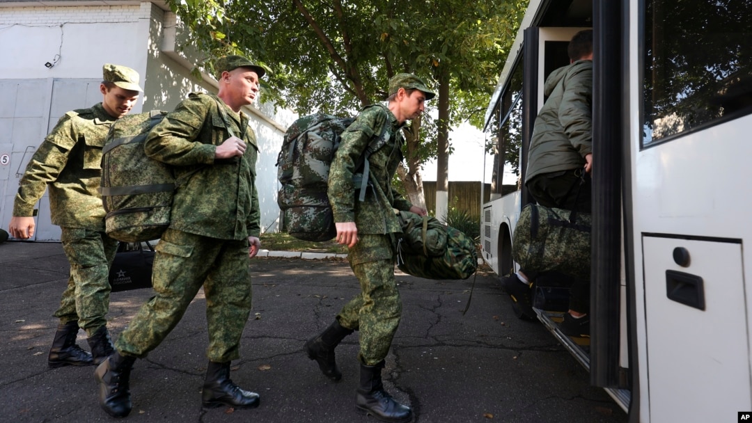 Recruits take a bus near a military recruitment center in Krasnodar, Russia. Human rights defenders say they have been inundated with pleas for help from thousands of migrants who have mistakenly enrolled in the Russian Army or been pressured to do so.