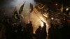 Pakistanis wave the national flag as they celebrate the cease-fire between Pakistan and India, in Hyderabad, Sindh Province, on May 10.