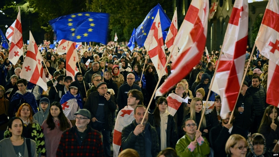 Protesters wave flags during a pro-Europe rally in Tbilisi on October 20, ahead of the parliamentary elections.