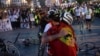 Serbian university students who cycled from Novi Sad, Serbia, hug on April 15 as they arrive in in Strasbourg, France, the heart of the European Union. 