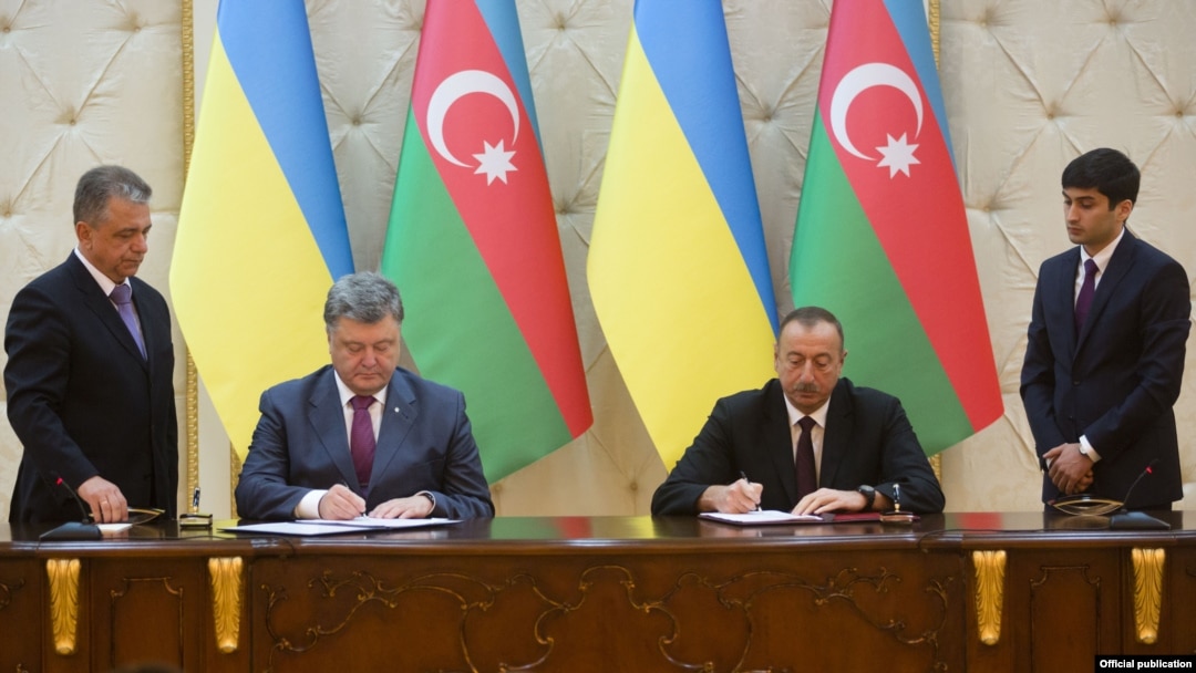 Президент України Петро Порошенко (ліворуч) та президент Азербайджану Ільгам Алієв підписують документи у Баку. 14 липня 2016 року