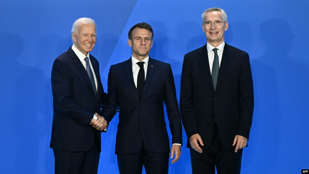 French President Emmanuel Macron (center) is welcomed by U.S. President Joe Biden (left) and NATO Secretary-General Jens Stoltenberg as they attend the NATO summit in Washington on July 10.