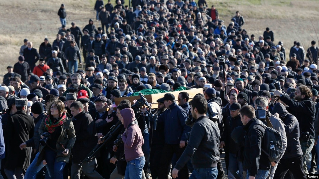 Crimean Tatars gather for the funeral of Reshat Ametov -- whose naked, bound, and apparently tortured body was discovered outside Simferopol -- on March 18.