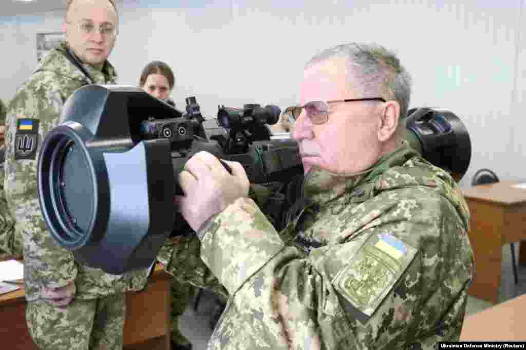 A senior Ukrainian military official holds one of the anti-tank weapons supplied by Britain during a training session for Ukrainian servicemen in Lviv. 