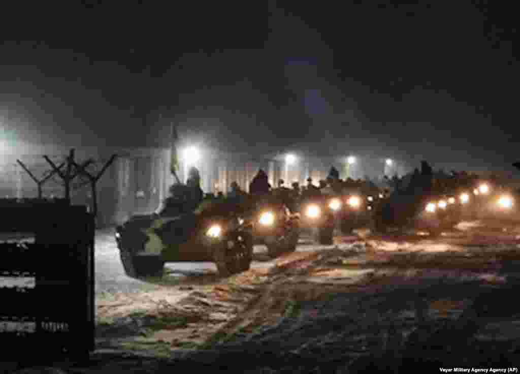 Belarusian military vehicles gather ahead of joint military drills with Russian forces in Belarus on January 25. Russia has sent an unspecified number of troops from the country's Far East to allied Belarus, which shares a border with Ukraine, for major war games planned in February. 