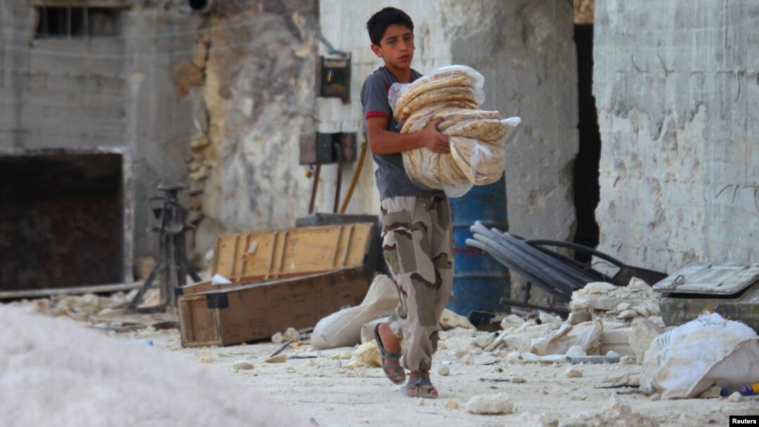 A boy carries bread in the Syrian city of Latamneh, which was reportedly hit two days ago by Russian air strikes. 
