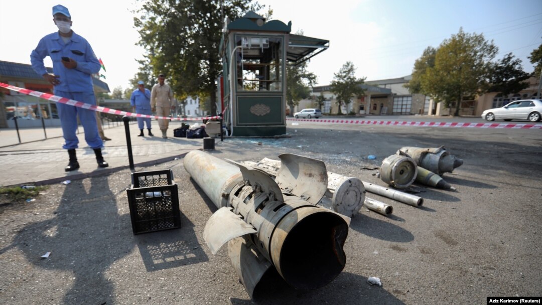 An Azerbaijani investigator stands near shell fragments in the town of Barda on October 29, 2020.