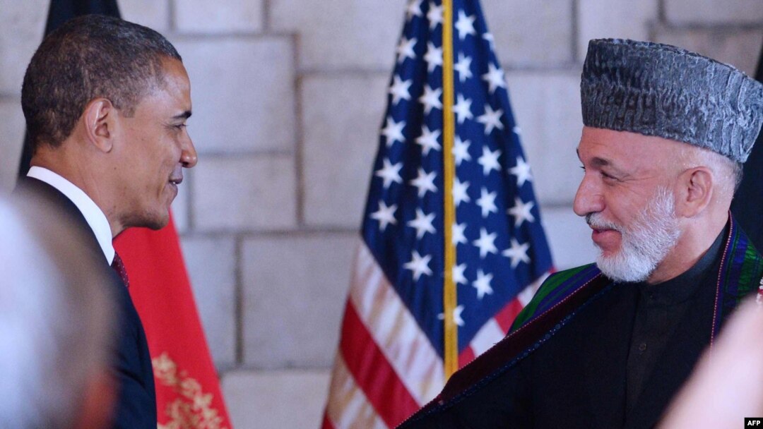 Afghan President Hamid Karzai (right) shakes hands with U.S. President Barack Obama after signing a strategic partnership agreement in Kabul.