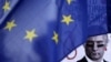 A poster depicting Russian President Vladimir Putin is seen behind an EU flag during a rally by the Czech Republic's Ukrainian community following Russia's invasion of Crimea, in Prague in 2014.