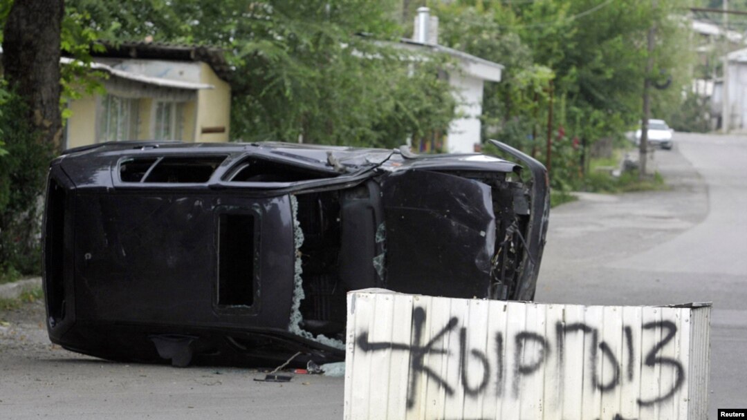 A concrete block with a sign saying "Kyrgyz Zone" stands in a street in the city of Osh on June 13.