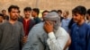 <p>Afghan refugees embrace each other before leaving for Afghanistan at a bus stand in Karachi. Thousands of Afghan refugees living in Pakistan have been forcibly repatriated since Pakistani authorities set an April 10 deadline for those without documents to leave the country.
