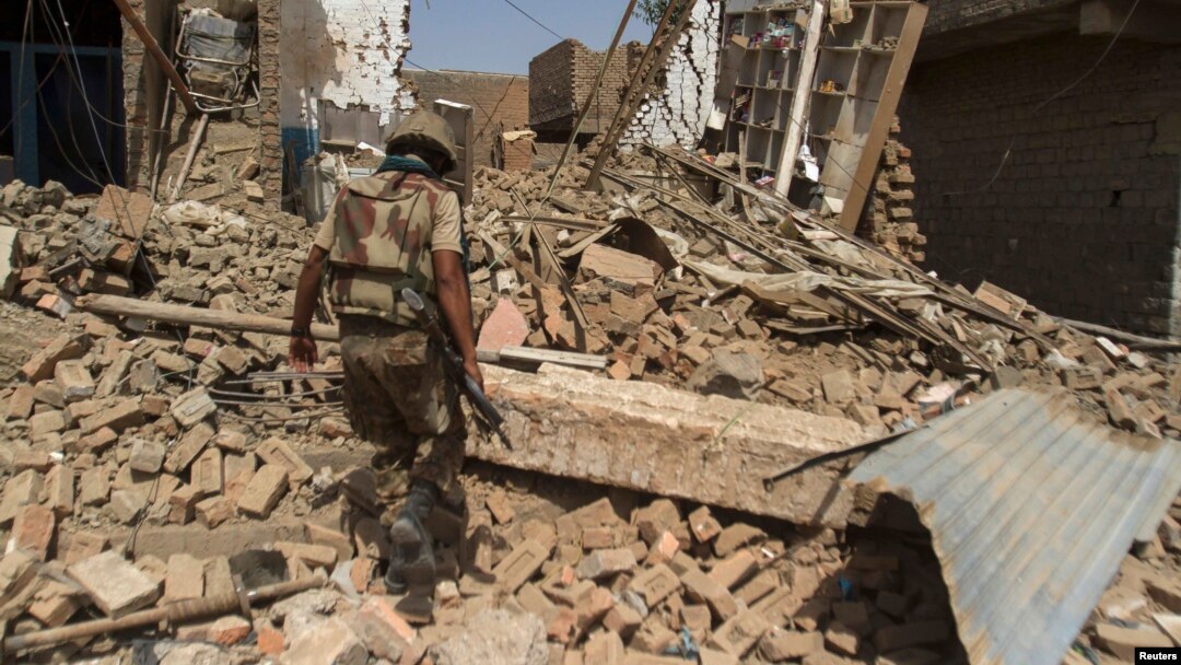 In the town of Miran Shah, North Waziristan, a Pakistani soldier inspects the site of a house destroyed during a military operation against Taliban militants in 2014.