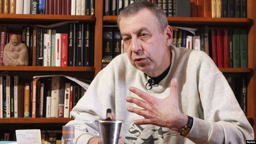 Former presidential candidate Andrey Sannikau speaks during an interview with Reuters at his apartment in Minsk.