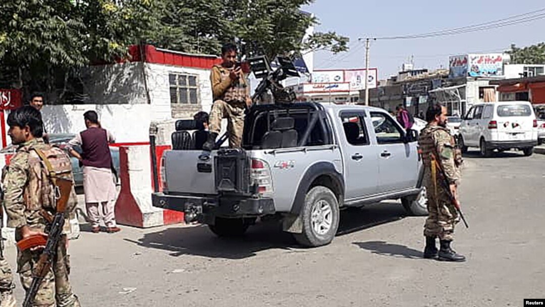 Afghan security forces stand guard at the entrance gate of Hamid Karzai International Airport in Kabul on August 15.