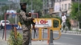 An Indian paramilitary trooper stands guard along a street in Srinagar on April 30, 2025.