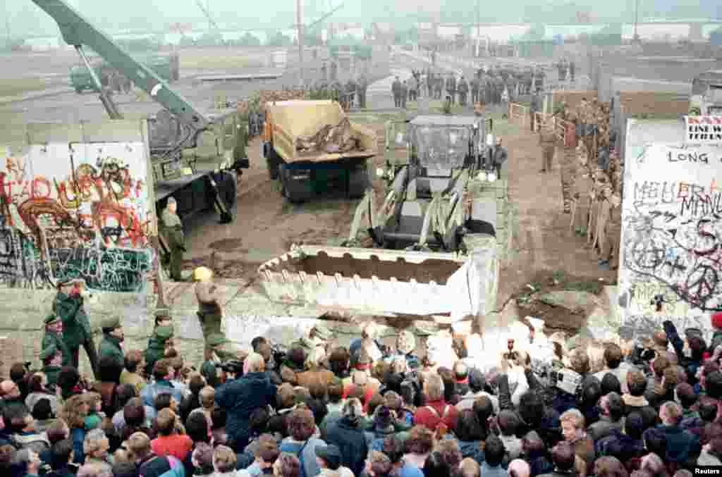 Листопад 1989 року: Падіння Берлінської стіни. Заява керівництва НДР спонукала тисячі людей прийти до стіни, що розділяла Німеччину. Прикордонники опустили зброю та пропустили людей. Стіну зруйнували &nbsp;