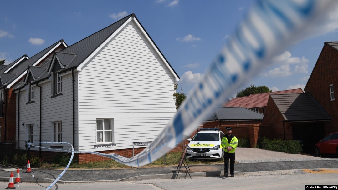 A police officer guards a cordon at a residential address in Amesbury, southern England, where police reported a man and woman were found unconscious.