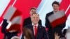 Karol Nawrocki, candidate for the 2025 Polish presidential election supported by Poland's right-wing Law and Justice (PiS) party, addresses supporters as exit polls were announced during their election night event at the Mala Warszawa Theatre in Warsaw, P