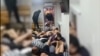 A video that has gone viral on social media shows Kyrgyz migrants being forced to crawl on the floor and lie on top of each other during a police raid in Moscow. 
