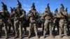 Moldovan soldiers line up next to military vehicles received by the United States at a ceremony in Chisinau, Moldova, on February 18. On April 9, the EU is set to green-light the bloc's largest-ever military aid package to the country, which borders Ukraine.