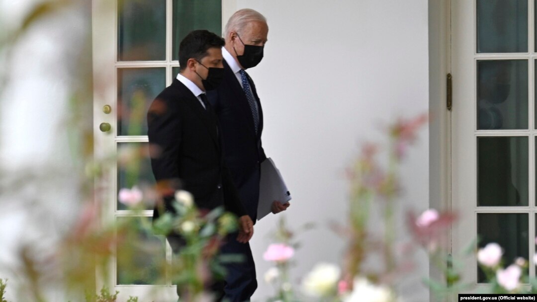 Volodymyr ZelenskIy (left) and Joe Biden walk in the White House in Washington during their meeting in September.