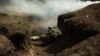 A soldier lies in a trench near Vuhledar, in Ukraine's Donetsk region.