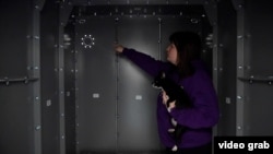 Kateryna Storozhuk shows the Life Capsule home shelter she installed in the spare room of her apartment in Bucha, Ukraine.