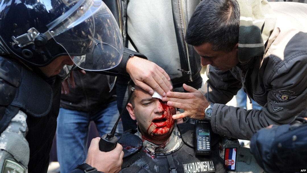 An injured riot police officer is cared for by colleagues during Belgrade's last gay-pride parade, in 2010.
